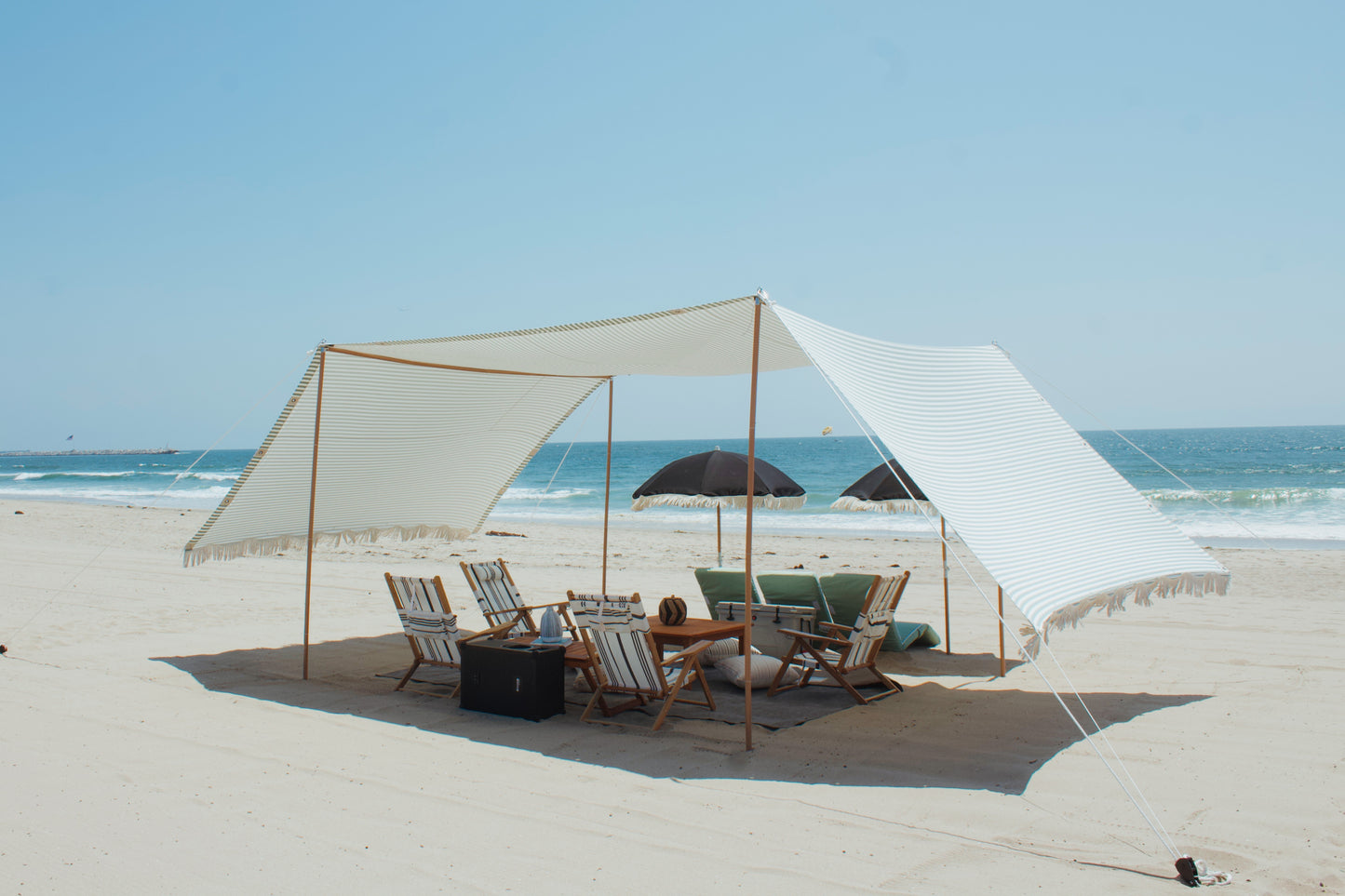 The Villa beach lounge event rental with beach lounges, chairs, and umbrellas on Marina Del Rey beach in LA