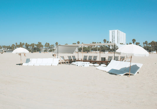 Large beach lounge rental with beach lounges and beach umbrellas in Santa Monica on the beach