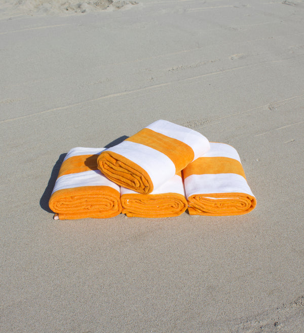 Beach necessities — umbrellas, towels and coolers